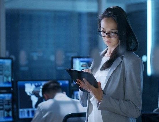 Woman reading a tablet in an office